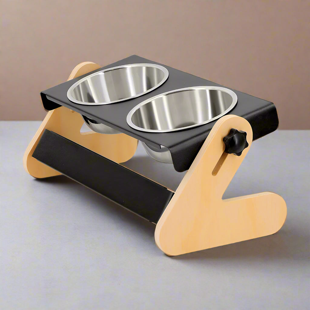 Pet feeding station with two stainless steel bowls on a black tray with wooden support.