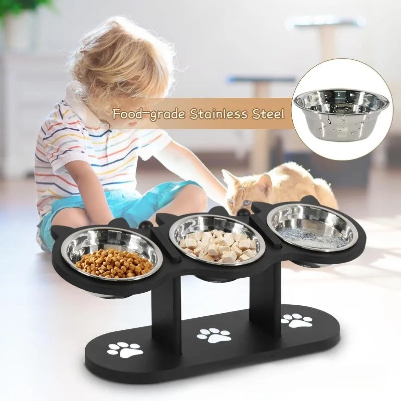 Pet feeding station with four bowls on a black stand, child and cat in the background.