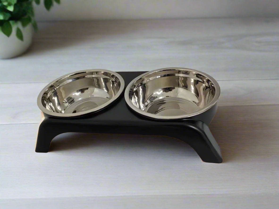 Pet food bowl stand with two stainless steel bowls on a white background