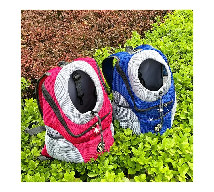 Two pet carriers, one pink and one blue, on a grassy background.