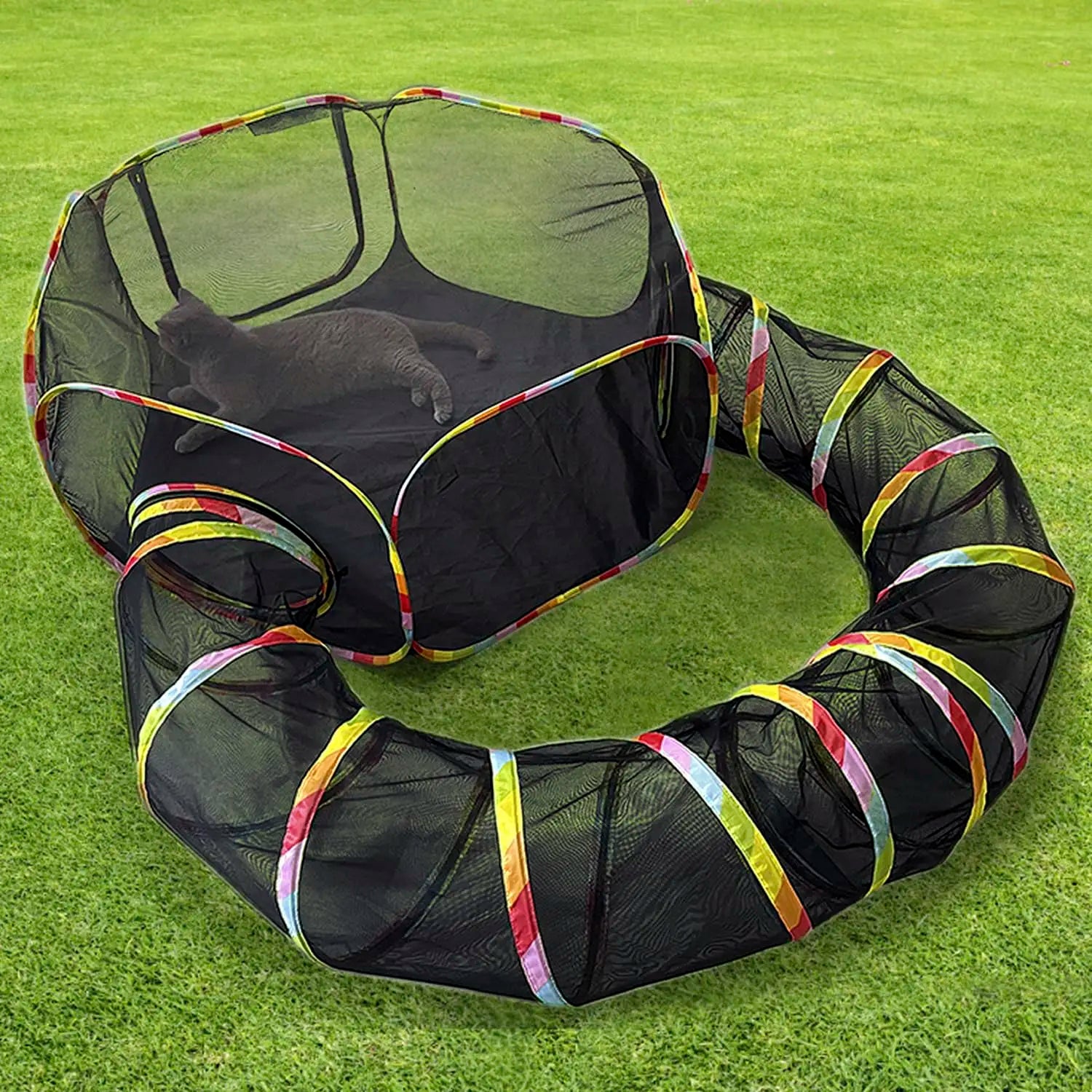 Black pet playpen with colorful edges on a grassy background