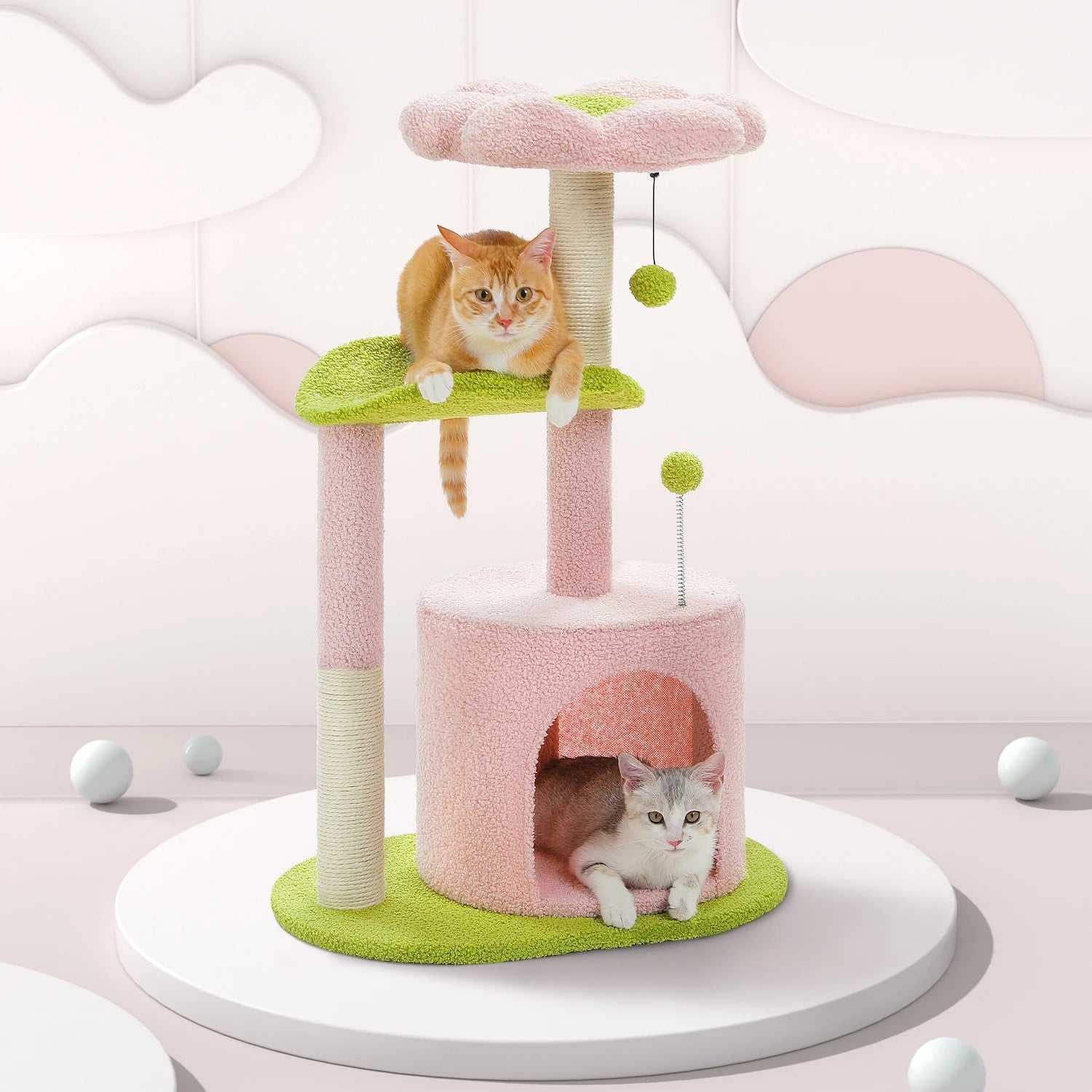 Pink and green cat tree with two cats on a white background