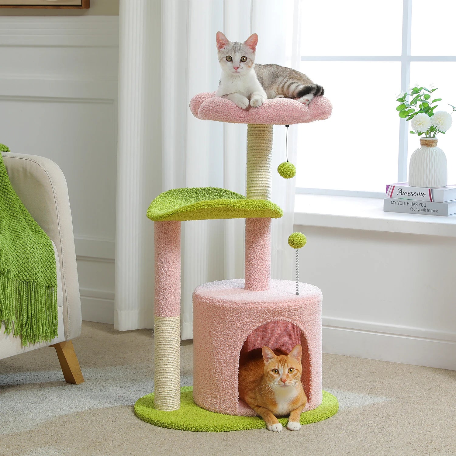 Cat tree with two cats on different levels in a room with a window and plant.
