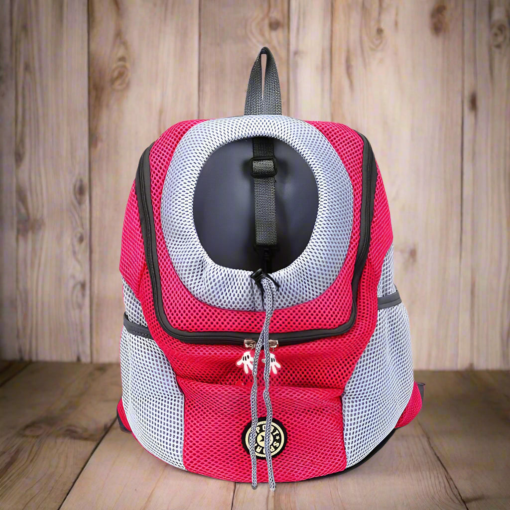 Pink and gray pet carrier backpack on a white background