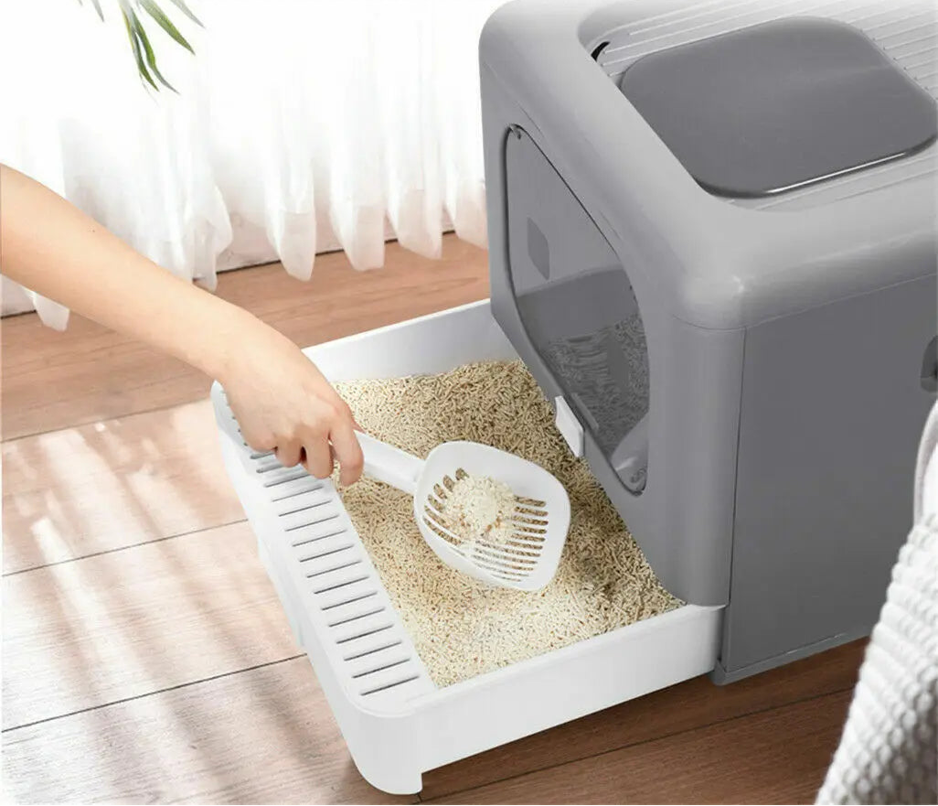 Cat litter box with drawer design for easy cleaning, on a wooden floor.