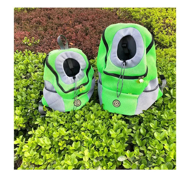 Two green and gray dog carriers on a grassy background