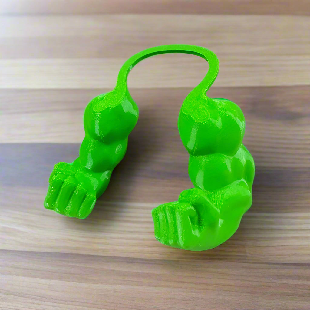 Green plastic toy with a unique design on a white surface