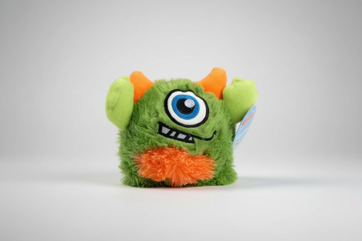 Light green Q-Monster plush dog toy in retail packaging — super squeak bouncing ball inside