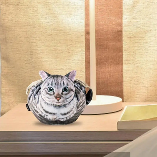 grey tabby on a desk bag