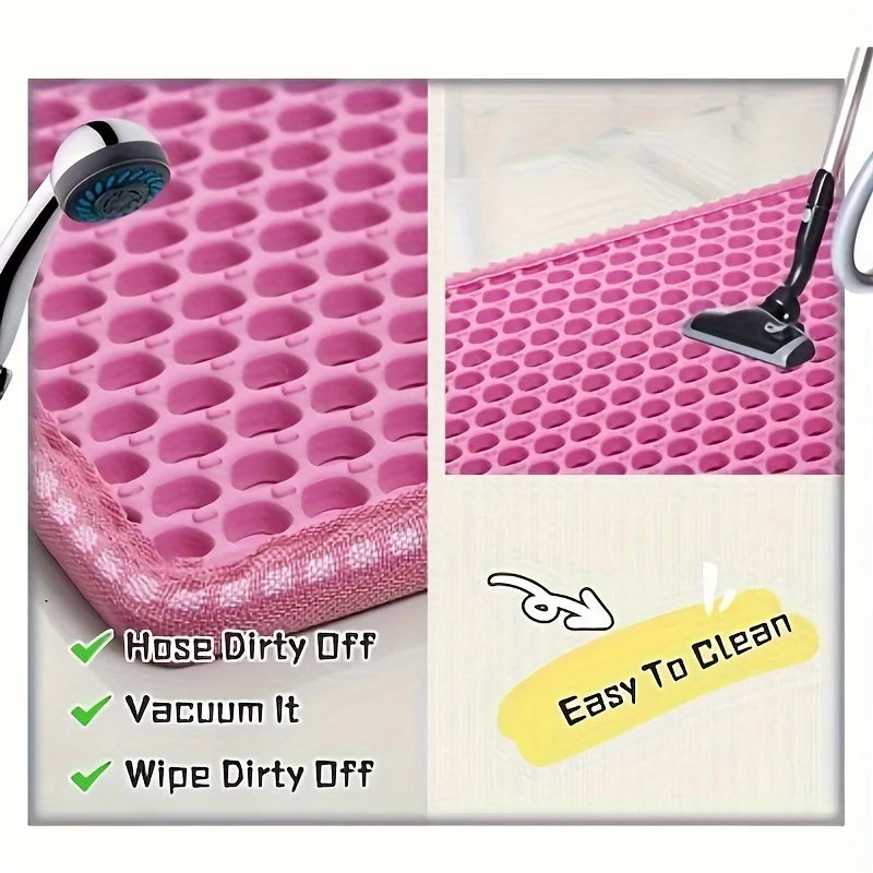 Pink mat with drainage holes being cleaned by a hose, vacuum, and wiped off, with text indicating ease of cleaning.