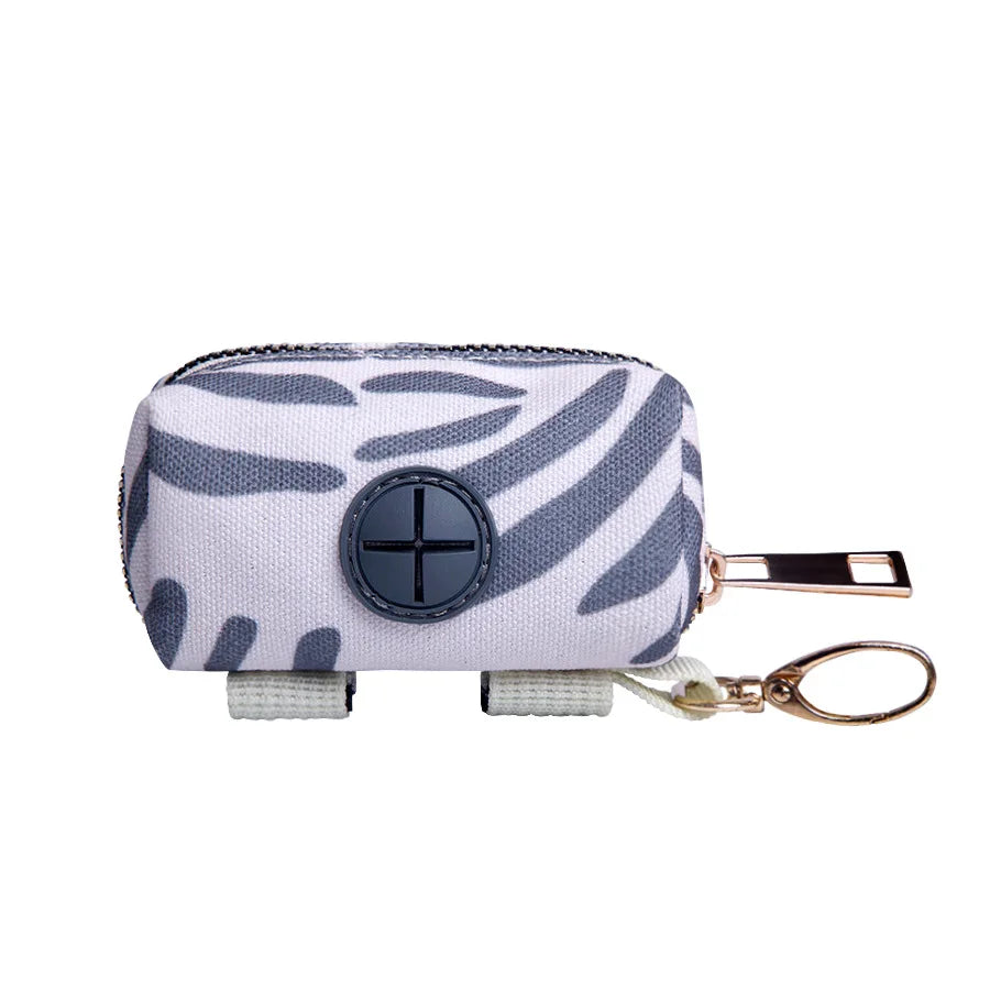 SniffWaggleNWalk PawPocket™ clip-on poop bag holder in Grey Brushstroke design — white and grey canvas with dispensing port and gold metal carabiner clip