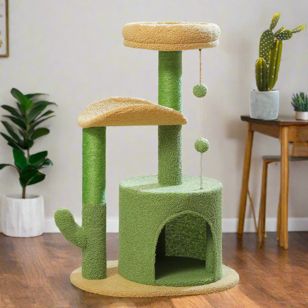 Green and beige cat tree with sniff waggle and walk branding in a room with a window and plants.