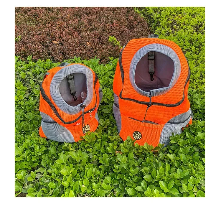 Two orange pet carriers on grass