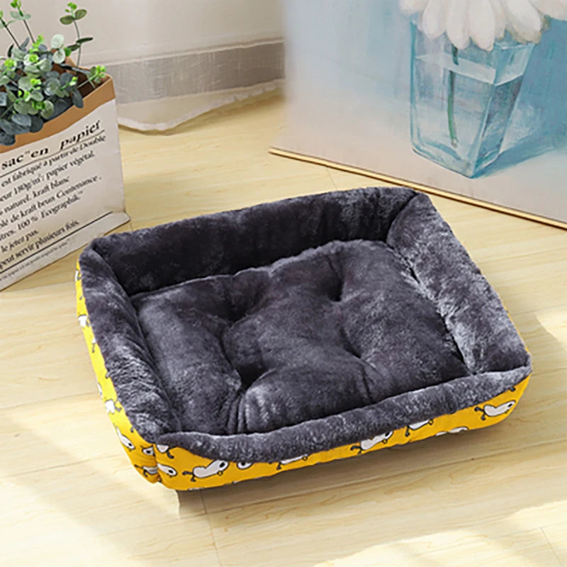 Gray pet bed with yellow base on a wooden floor