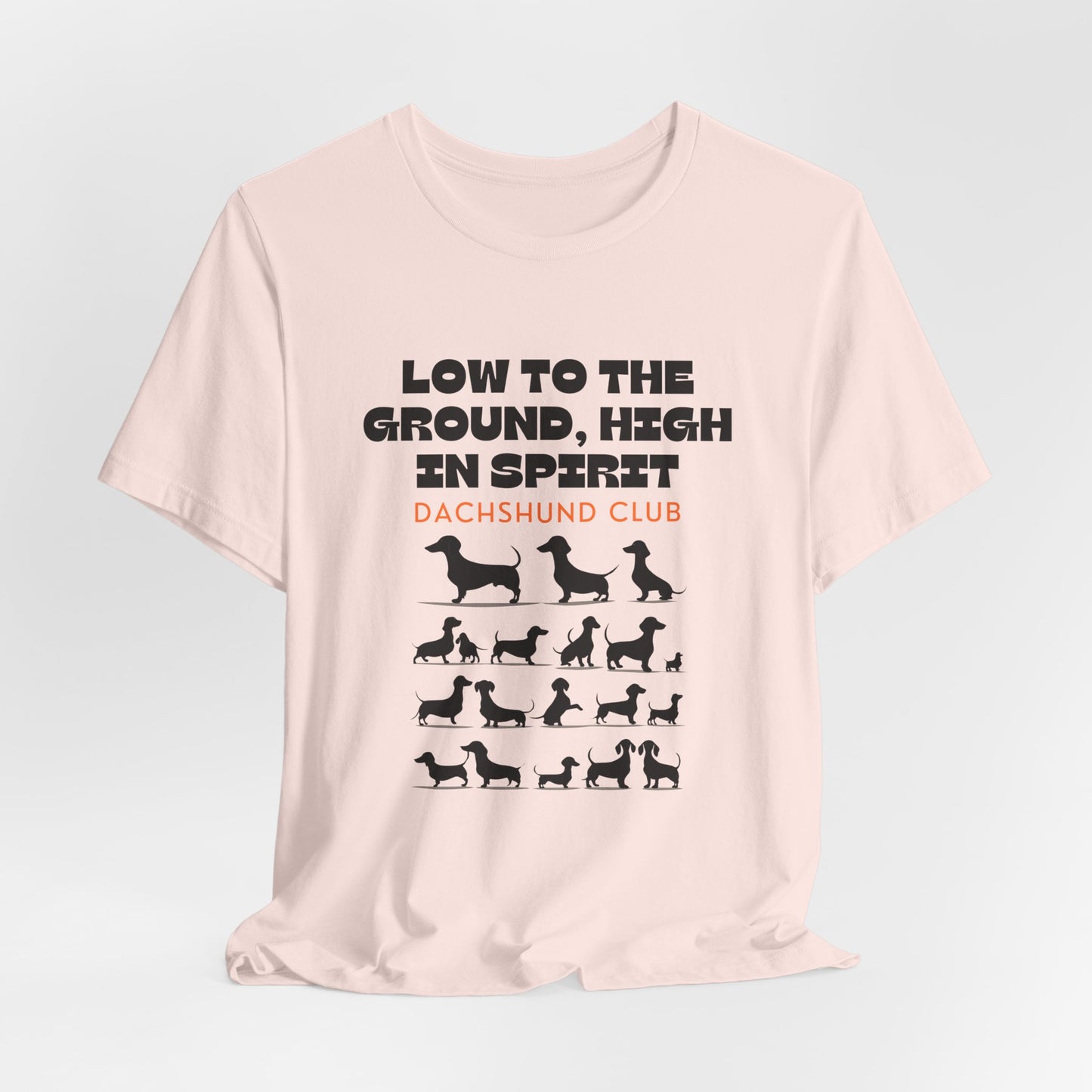 Soft Pink Dachshund Club graphic tee laid flat showing Low to the Ground print