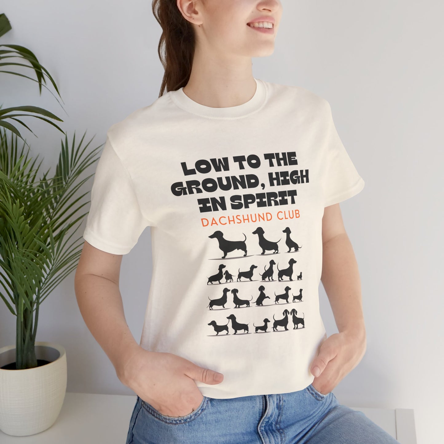 Woman wearing Natural Dachshund Club t-shirt with dachshund silhouettes design