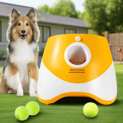 Orange and white PawFetch automatic ball launcher on grass with three 2 inch mini tennis balls in front.