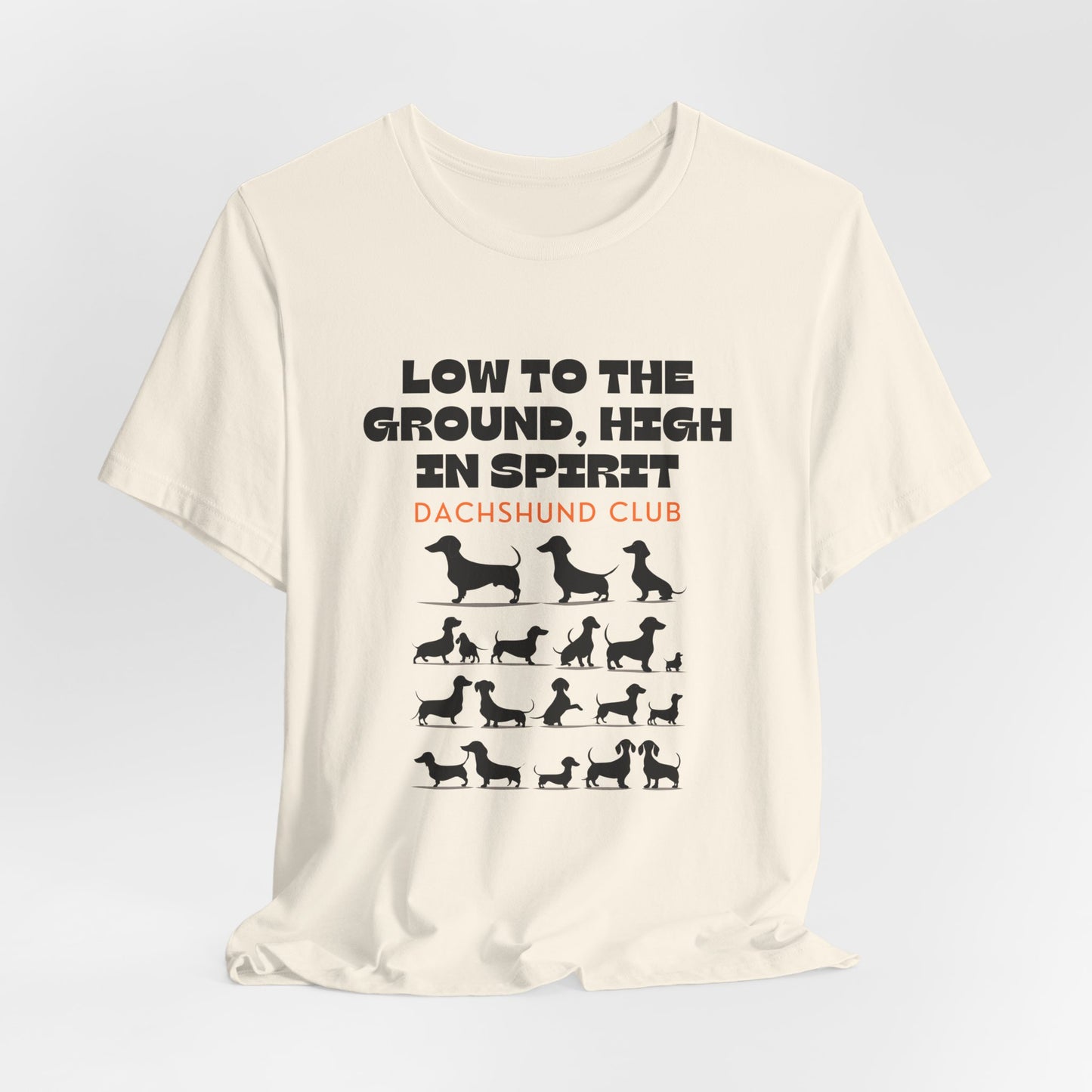 Natural Dachshund Club graphic tee laid flat showing Low to the Ground High in Spirit print
