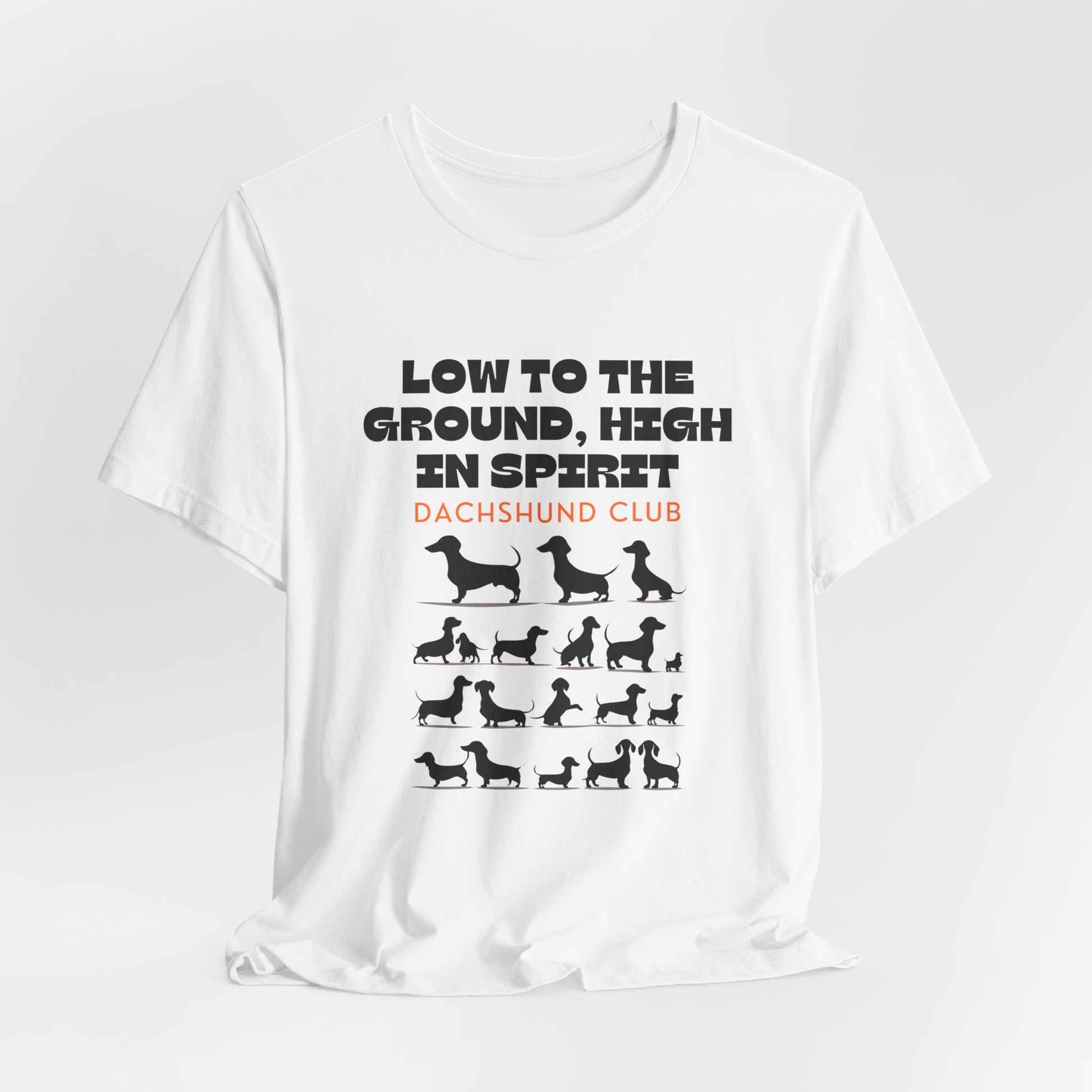 White Dachshund Club graphic tee draped flat showing Low to the Ground High in Spirit print