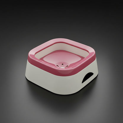 Dusky pink anti-spill dog water bowl with floating disc, three-quarter angle on light worktop, multi-pet friendly. 