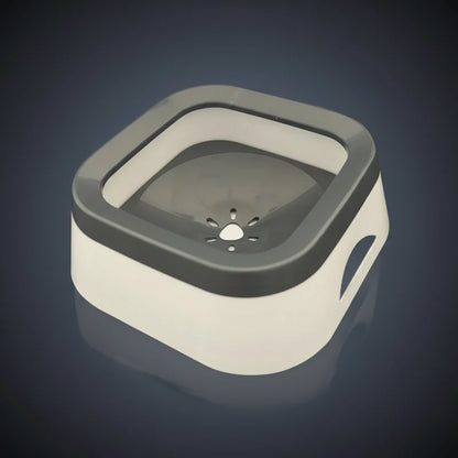 Stone grey anti-spill dog water bowl with floating disc on a kitchen worktop, three-quarter angle, splash-free design.