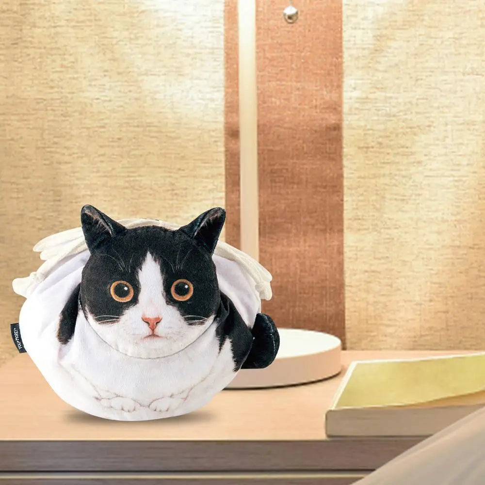 Calico tortoiseshell cat face plush drawstring pouch on a white dressing table with mirror and makeup