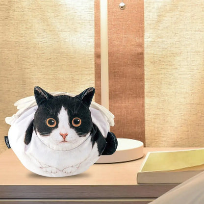 Calico tortoiseshell cat face plush drawstring pouch on a white dressing table with mirror and makeup