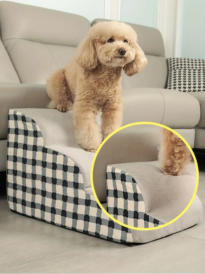 Dog sitting on a checkered pet ramp in a living room.