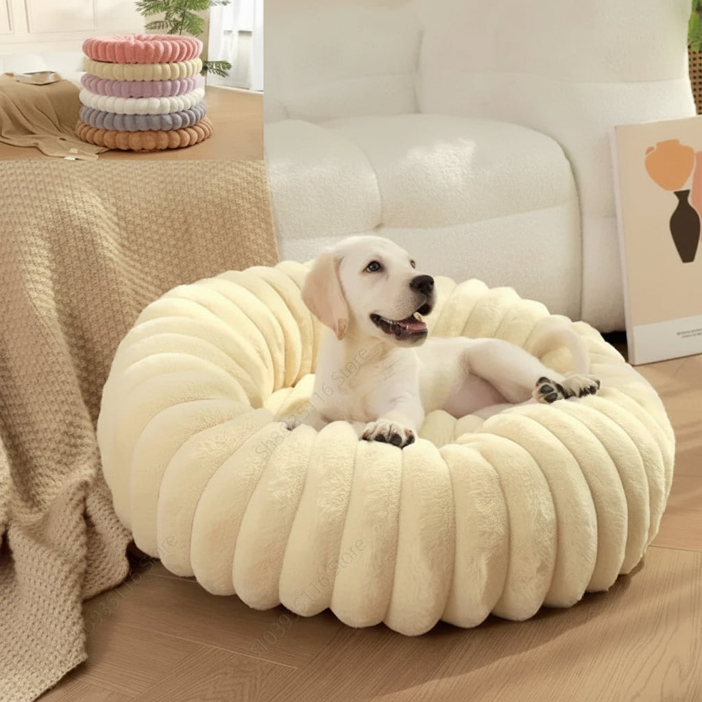  Cream ribbed faux rabbit-fur plush round donut pet bed on wooden floor beside sofa