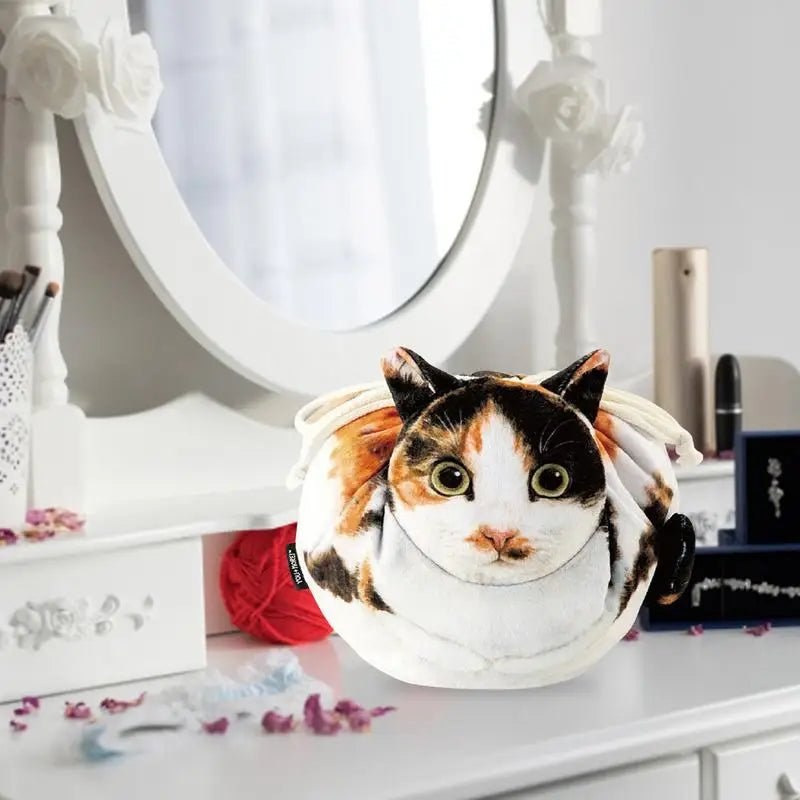 Four cat face plush pouches flat lay — tuxedo, calico, ginger tabby and grey tabby on white background cat