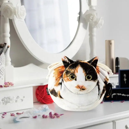 Four cat face plush pouches flat lay — tuxedo, calico, ginger tabby and grey tabby on white background cat