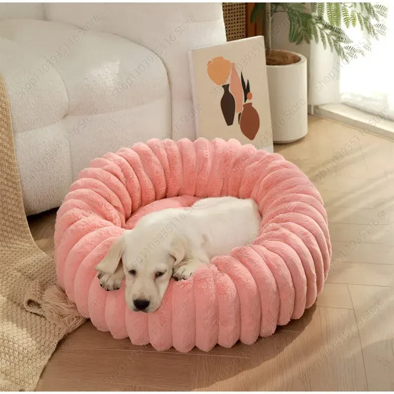 White Labrador puppy sleeping in pink ribbed plush donut dog bed 60cm diameter
