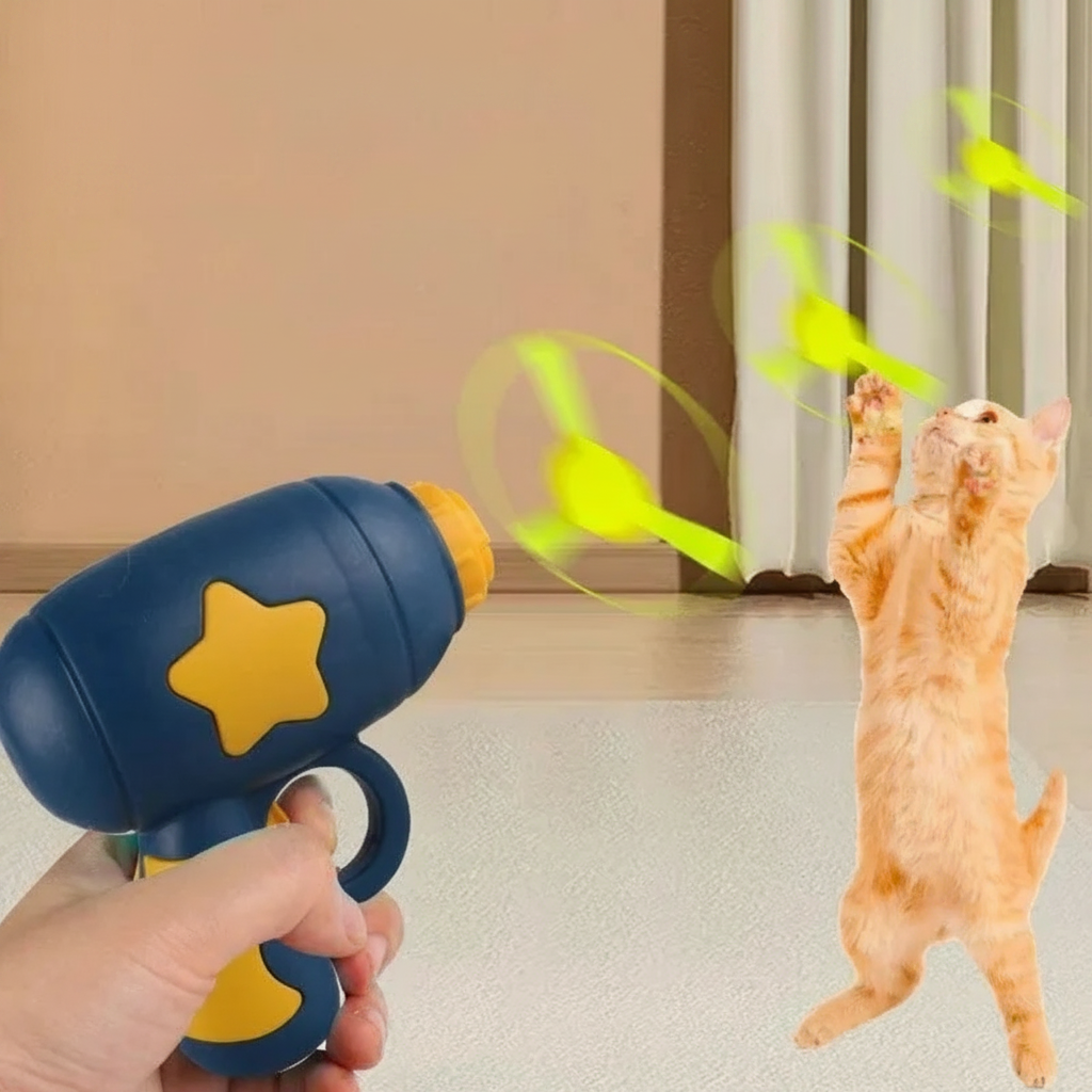 Navy blue spring-loaded disc launcher cat toy with yellow star detail and spinning disc, white background