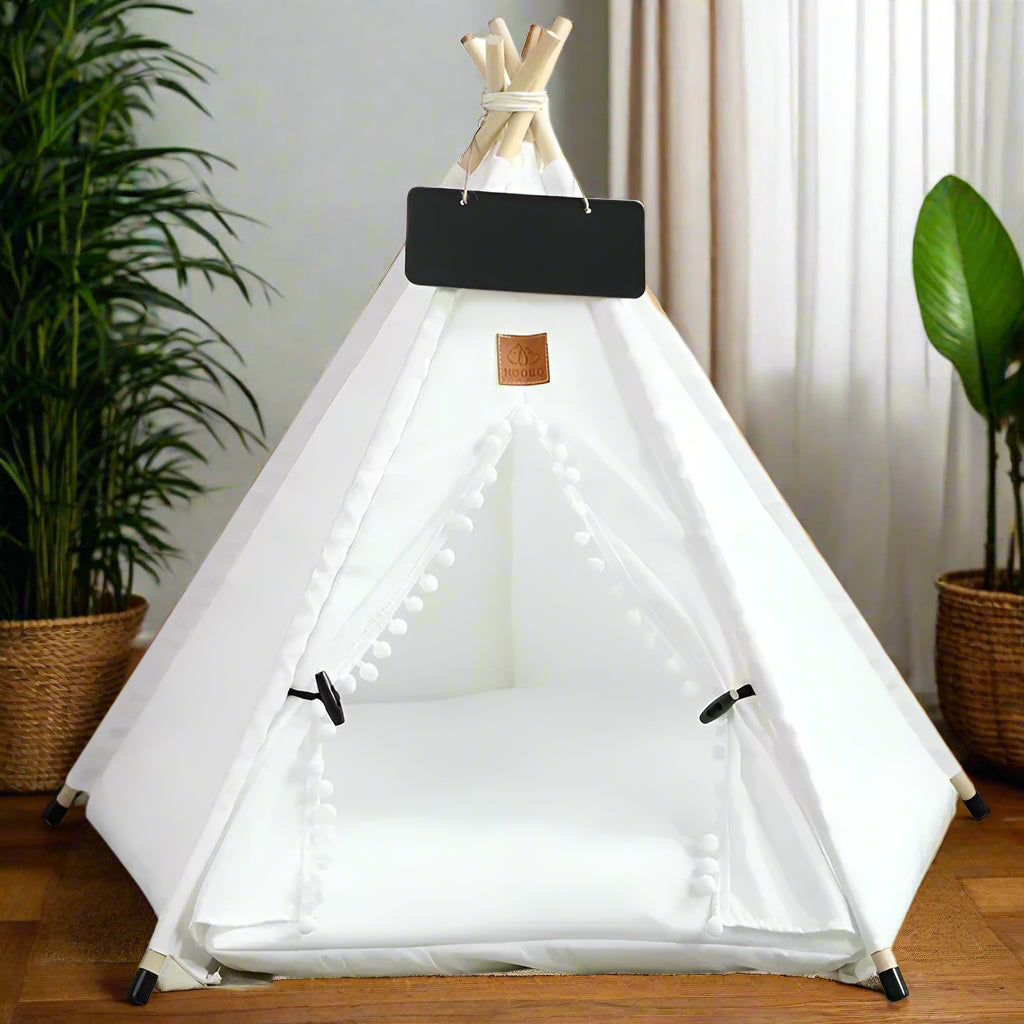 White canvas pet teepee with pom-pom trim — PawTee™ wooden frame cat teepee with cat settled inside on cushion