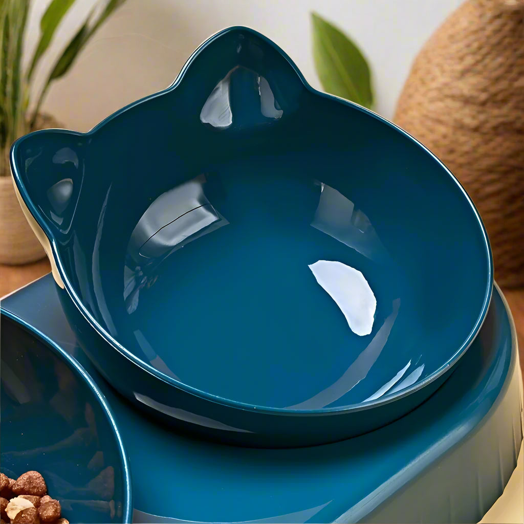  Hand lifting one of the removable cat-ear shaped food bowls from the PawTrio™ base to show the multi-directional card slot