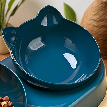  Hand lifting one of the removable cat-ear shaped food bowls from the PawTrio™ base to show the multi-directional card slot