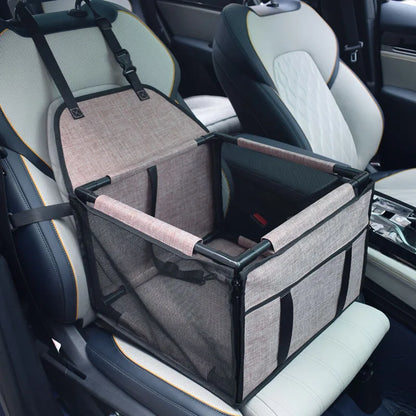 Small terrier sitting comfortably inside PupRide dog car booster seat strapped to back seat