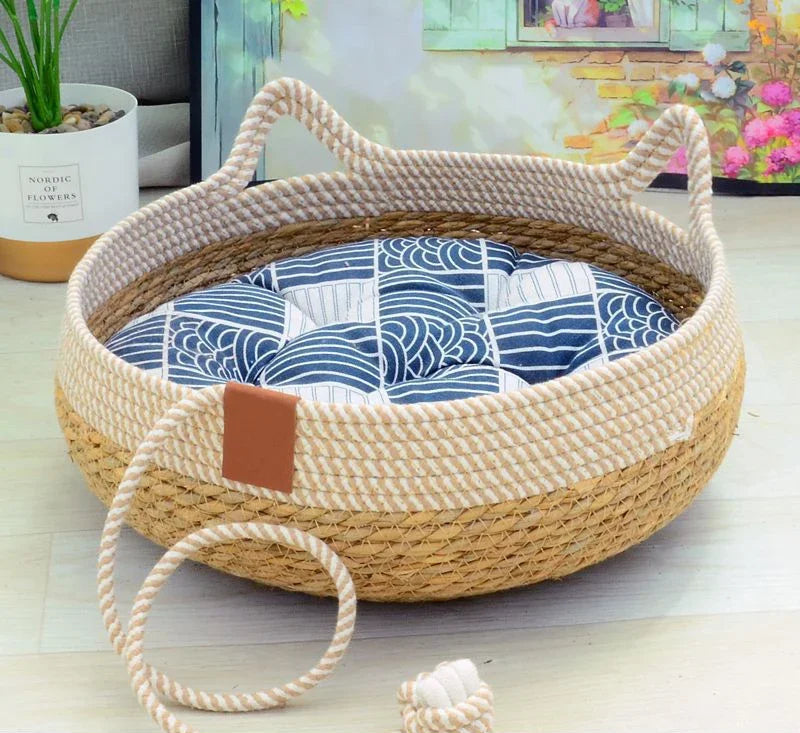 PawNest woven rope cat basket bed, angled view showing cat-ear rim and blue patterned cushion