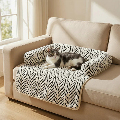 PawGuard plush sofa protector cushion draped over a sofa arm, white herringbone pattern, with a cat resting on top