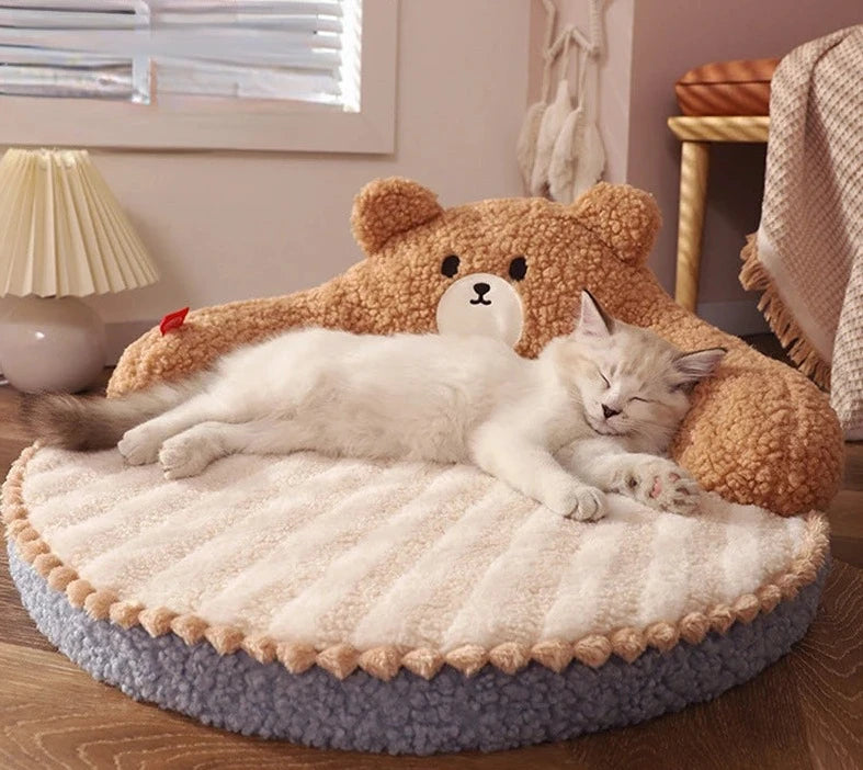 Cat curled up inside PoshPup HugNest™ character hug bed — 52cm round plush nest with pom-pom trim