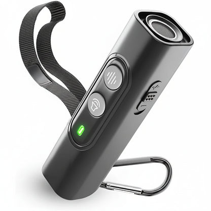 Soft black handheld ultrasonic dog bark training device with black lanyard and metal carabiner clip on neutral surface black version 