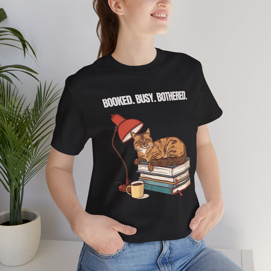 Booked. Busy. Bothered. cat t-shirt — front view on model