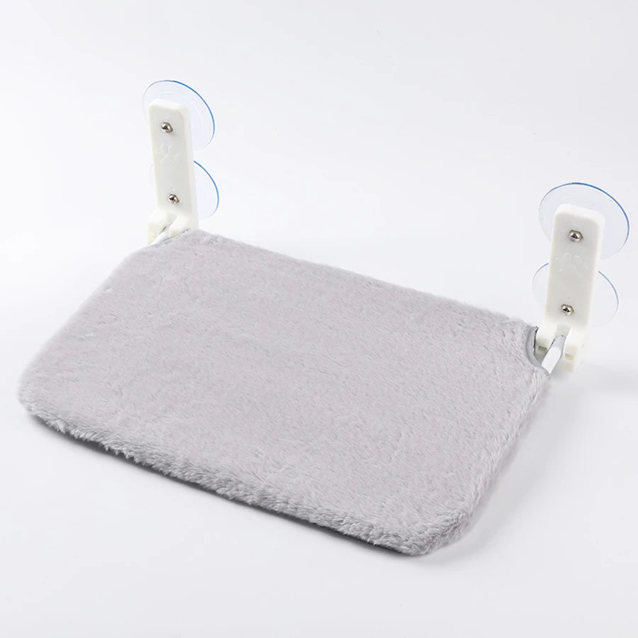 Grey plush cat window hammock with two suction cup brackets on a white background