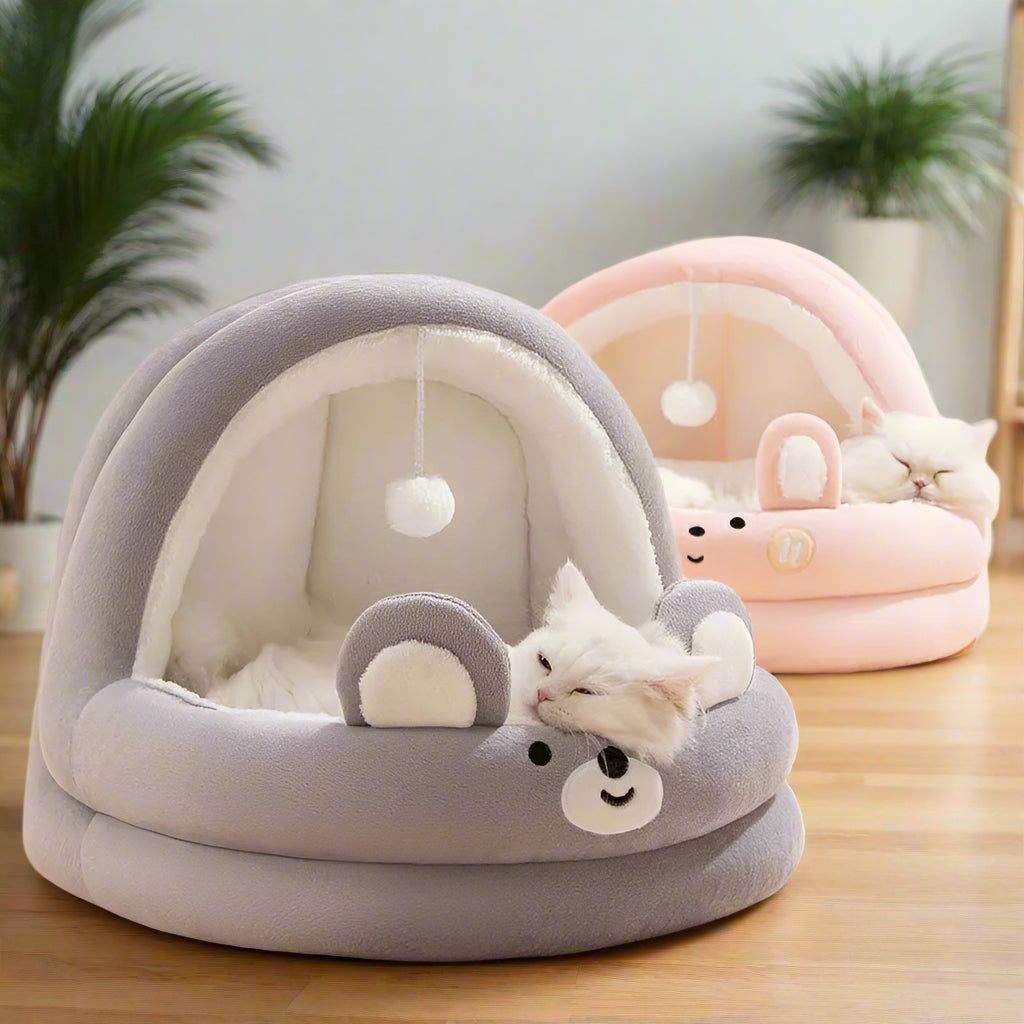 PawCave bear arch cave bed in grey — front view showing wide open arch entrance and dangling pom-pom toy