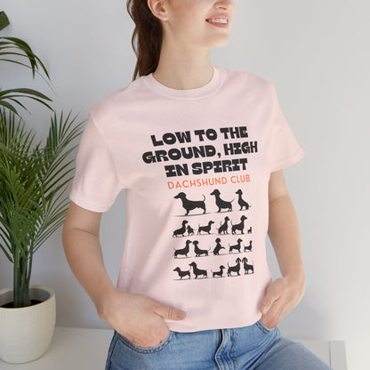 Woman wearing Soft Pink Dachshund Club t-shirt with sausage dog design