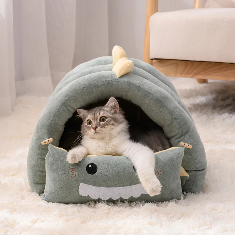PawBurrow dinosaur cave bed lifestyle photo — cat or small dog inside enclosed den — SniffWaggleNWalk