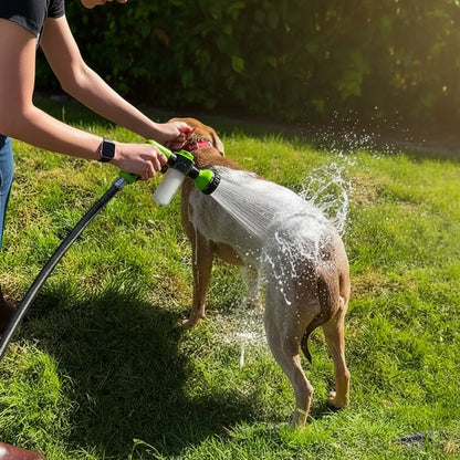 Dog shower spray gun held in hand for scale with a medium-sized dog visible in the background, ready for a bath.