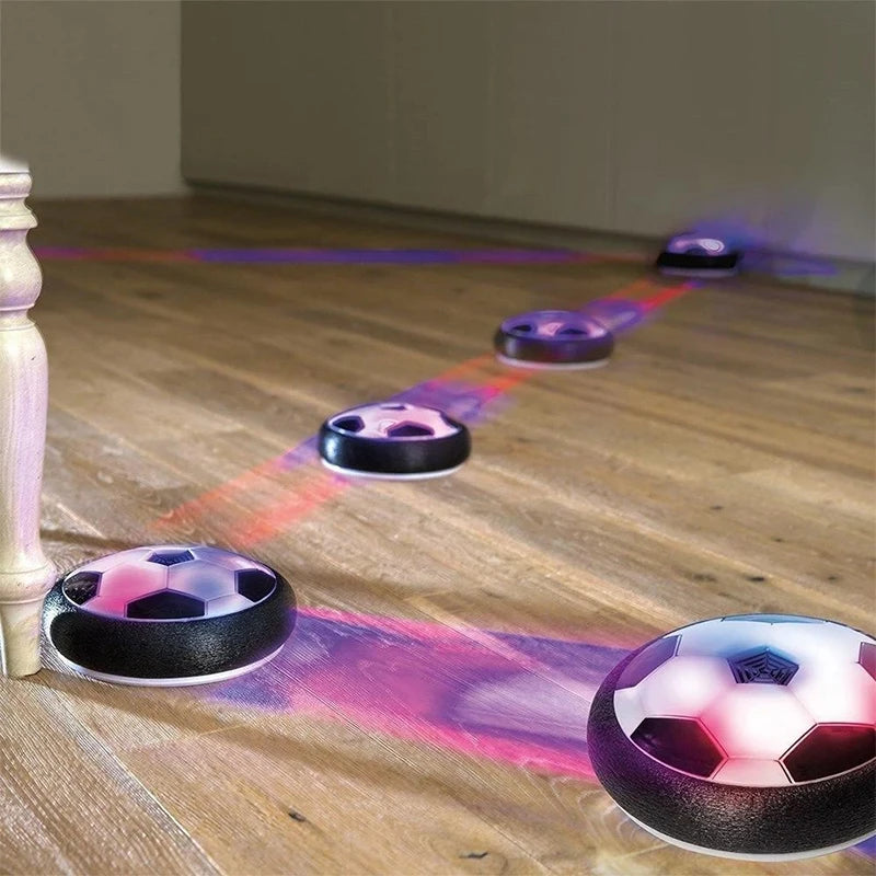 Electric hover football dog toy gliding across carpet with bowling pins — interactive play
