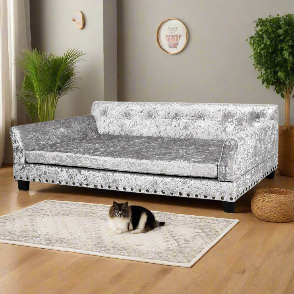 Great Dane lounging on XL silver crushed velvet dog sofa bed in luxury interior