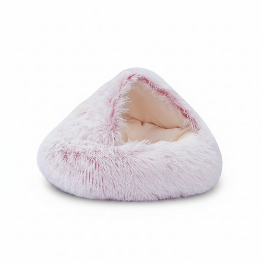 PawCave™ long-pile plush igloo cat cave bed in pink, showing curved front opening and shaggy exterior